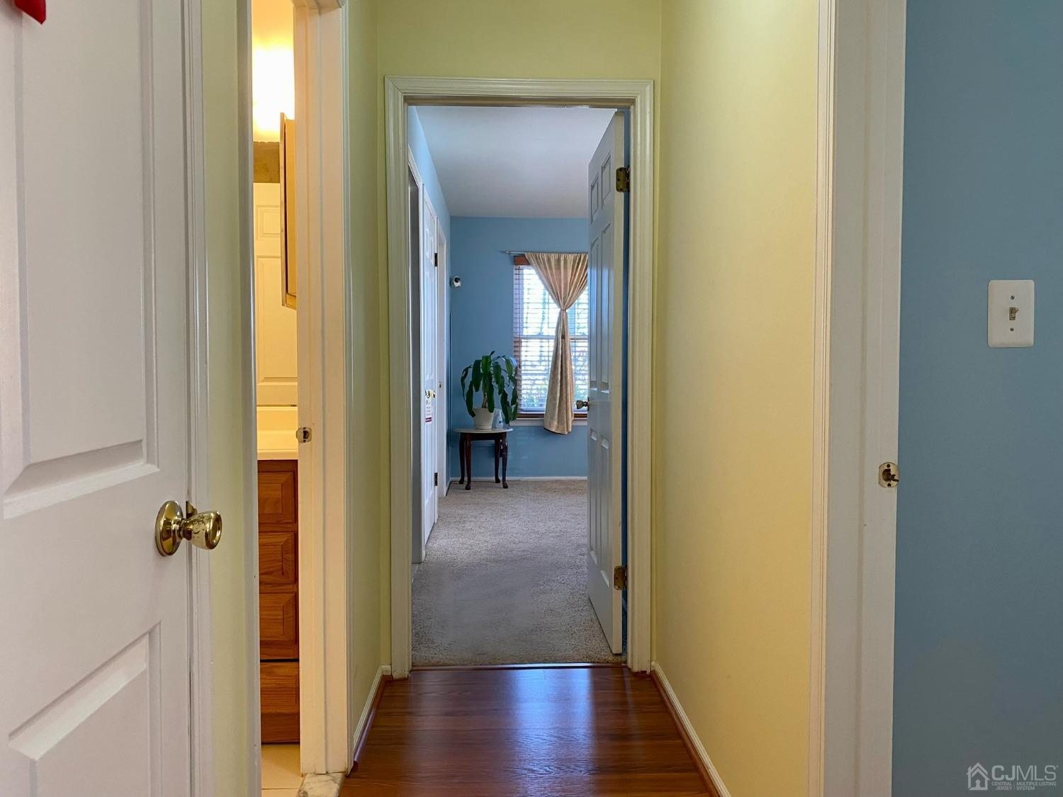 51 Boulder Drive Edison, NJ 08817 - Photo 10 of 24 a view of a hallway with wooden floor and a bathroom