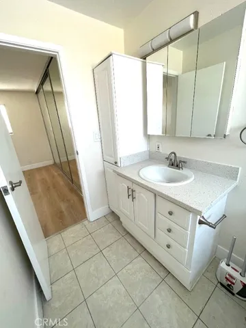 a bathroom with a double vanity sink a mirror and a shower