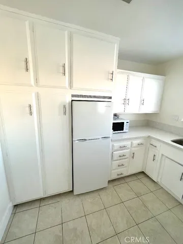a kitchen with a sink a stove and cabinets