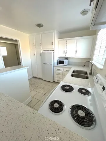 a kitchen with a stove a sink and a refrigerator