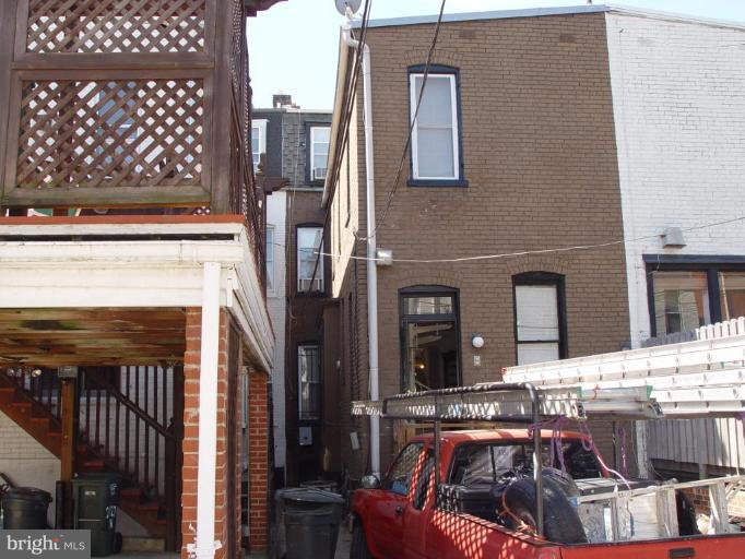 2129 N Street Northwest Washington, DC 20037 - Photo 10 of 14 rear of building with large truck