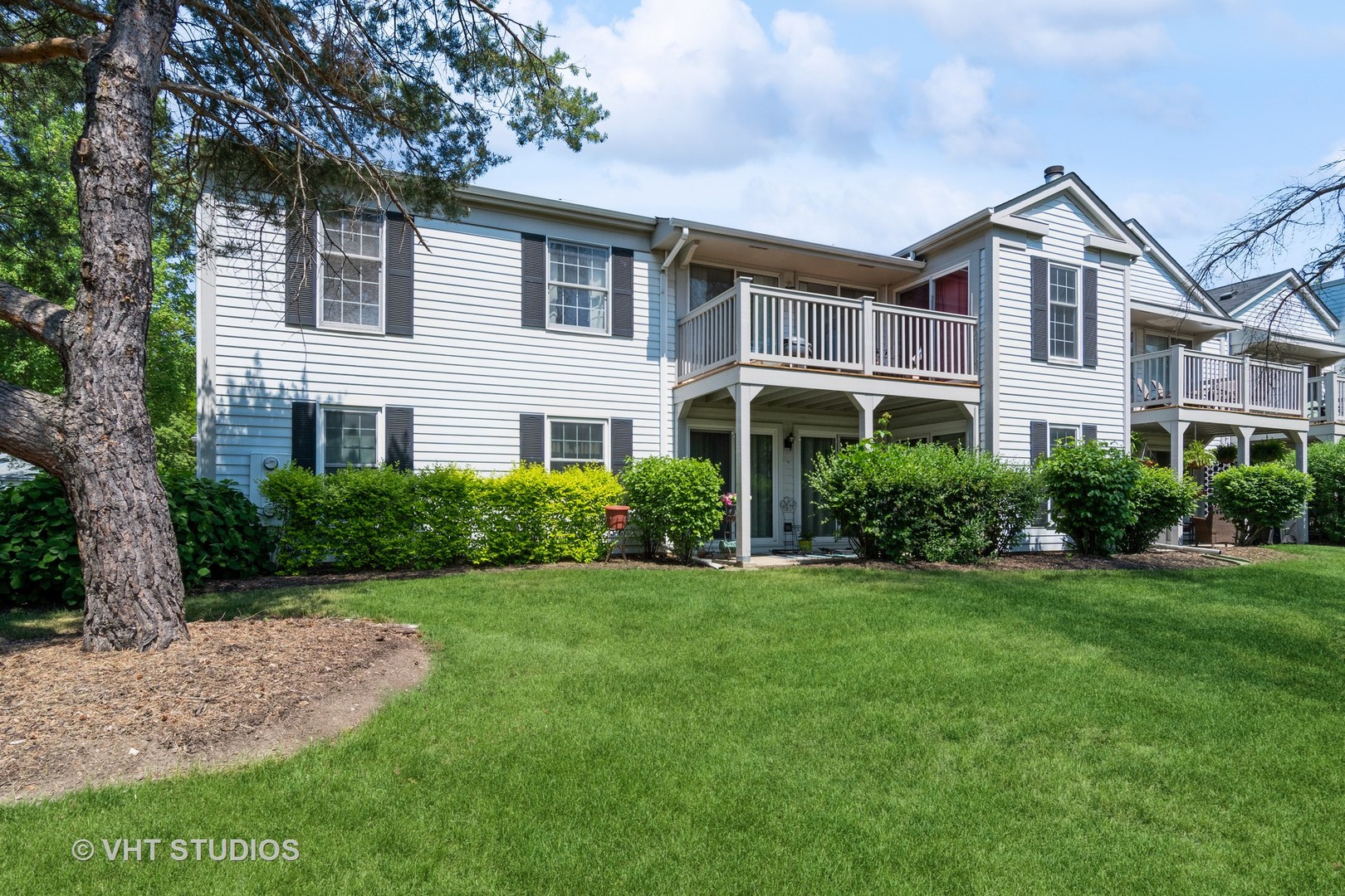 2124\ Lancaster Circle, Unit 202A Naperville, IL 60565 - Photo 12 of 14 a front view of a house with a yard