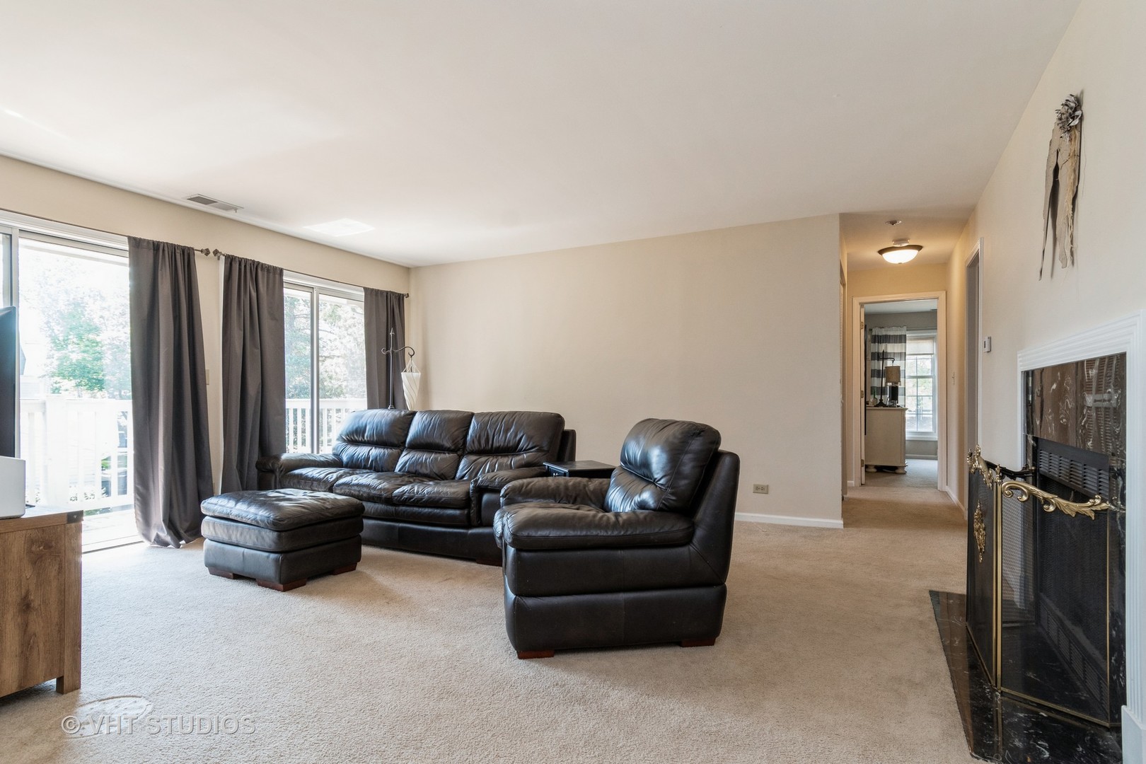2124\ Lancaster Circle, Unit 202A Naperville, IL 60565 - Photo 4 of 14 a living room with furniture a large window and a flat screen tv