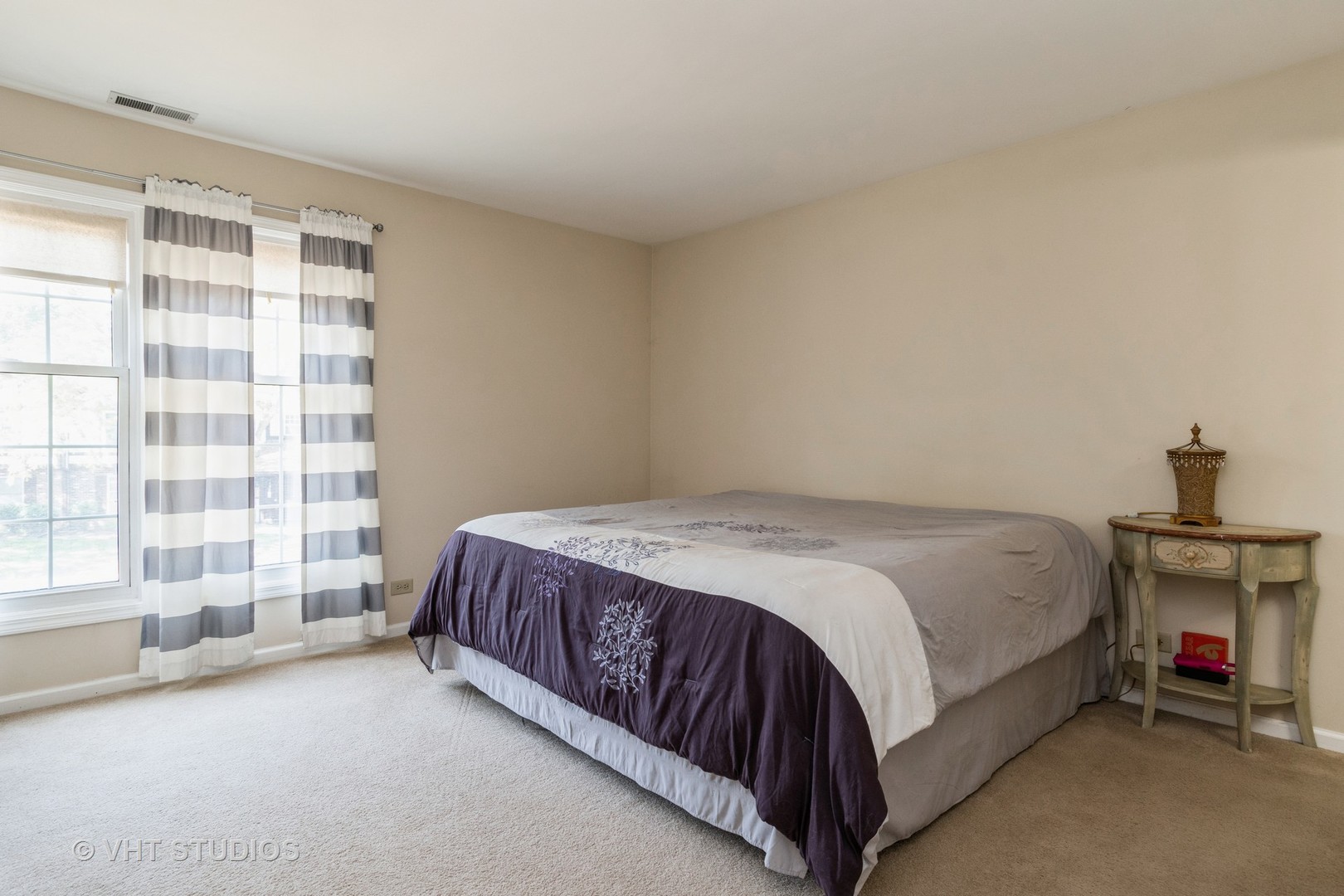 2124\ Lancaster Circle, Unit 202A Naperville, IL 60565 - Photo 5 of 14 a spacious bedroom with a bed and a large window