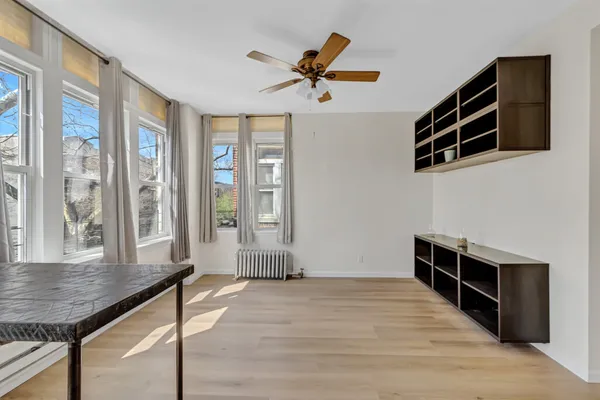 a view of a livingroom with furniture cabinets and wooden floor