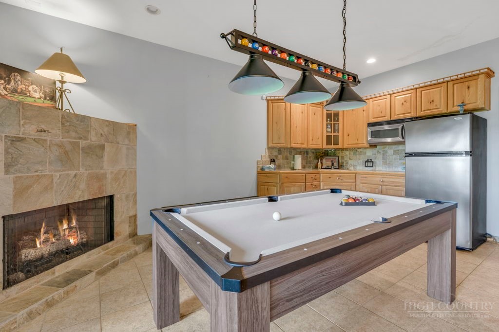 2229 Elk Ridge Road Ferguson, NC 28624 - Photo 36 of 42 a kitchen with a refrigerator a table and chairs