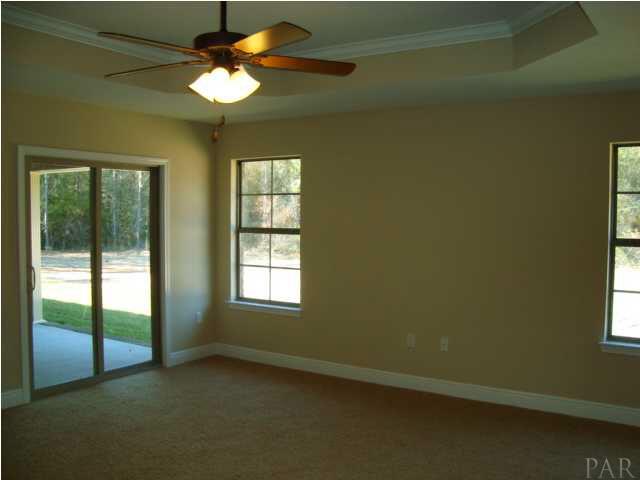 2908 Wallace Lake Road Pace, FL 32571 - Photo 12 of 23 Master Bedroom with raised ceiling and sliding glass doors leading to Back Porch