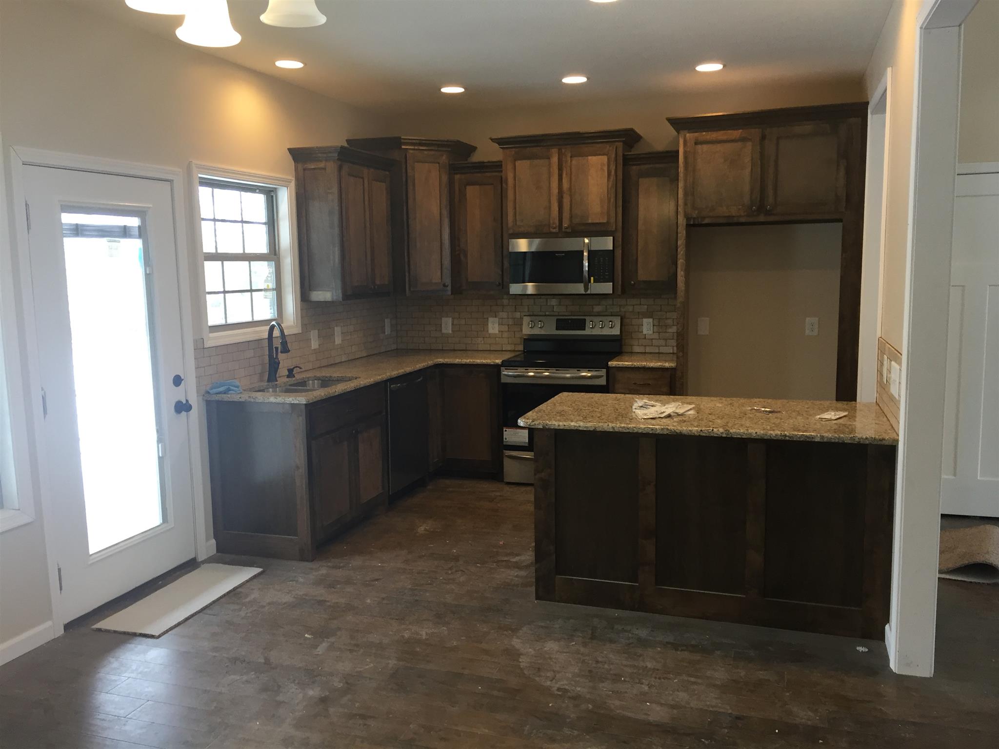 385 South Ray Road Portland, TN 37148 - Photo 3 of 8 a kitchen with stainless steel appliances granite countertop a stove a sink and a refrigerator