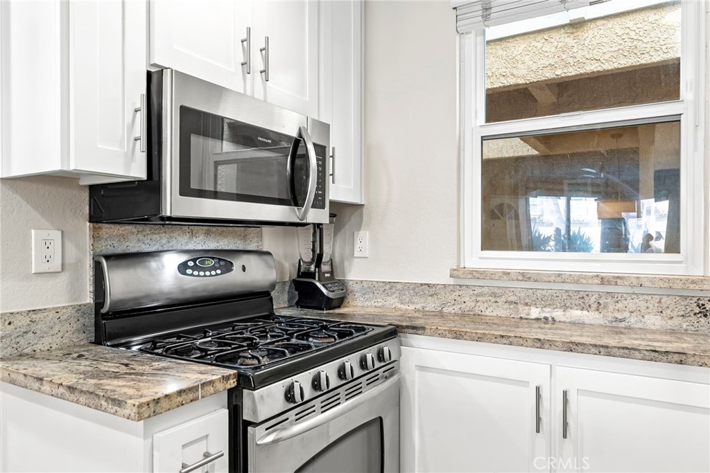 2000 Pacific Coast Highway, Unit 102 Huntington Beach, CA 92648 - Photo 13 of 35 a stove top oven sitting inside of a kitchen