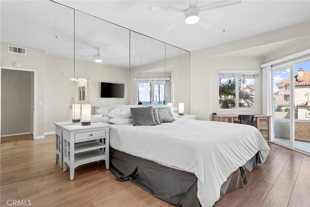 2000 Pacific Coast Highway, Unit 102 Huntington Beach, CA 92648 - Photo 18 of 35 a bedroom with a bed window and table