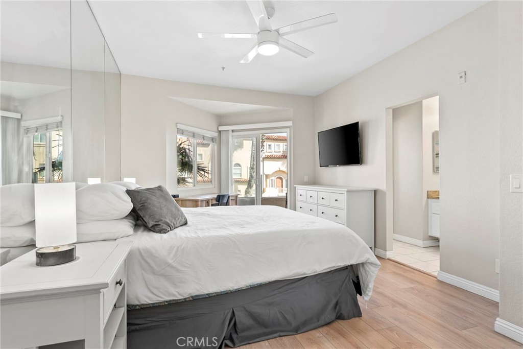 2000 Pacific Coast Highway, Unit 102 Huntington Beach, CA 92648 - Photo 19 of 35 a bedroom with a large bed a flat tv screen and a dresser