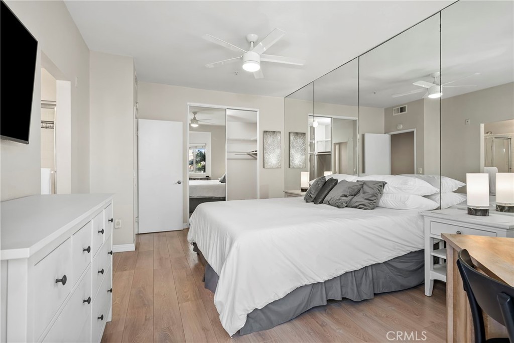2000 Pacific Coast Highway, Unit 102 Huntington Beach, CA 92648 - Photo 20 of 35 a spacious bedroom with a bed and a flat tv screen on dresser