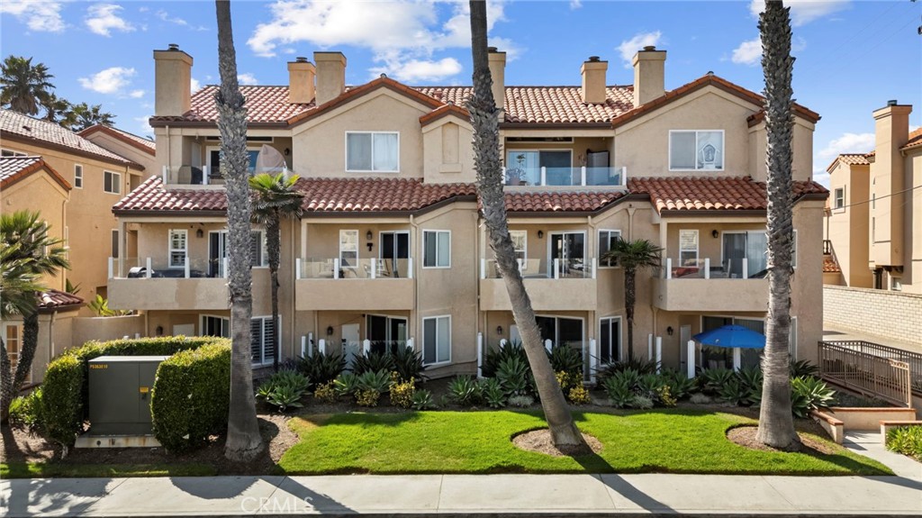 2000 Pacific Coast Highway, Unit 102 Huntington Beach, CA 92648 - Photo 2 of 35 a front view of a house with a yard