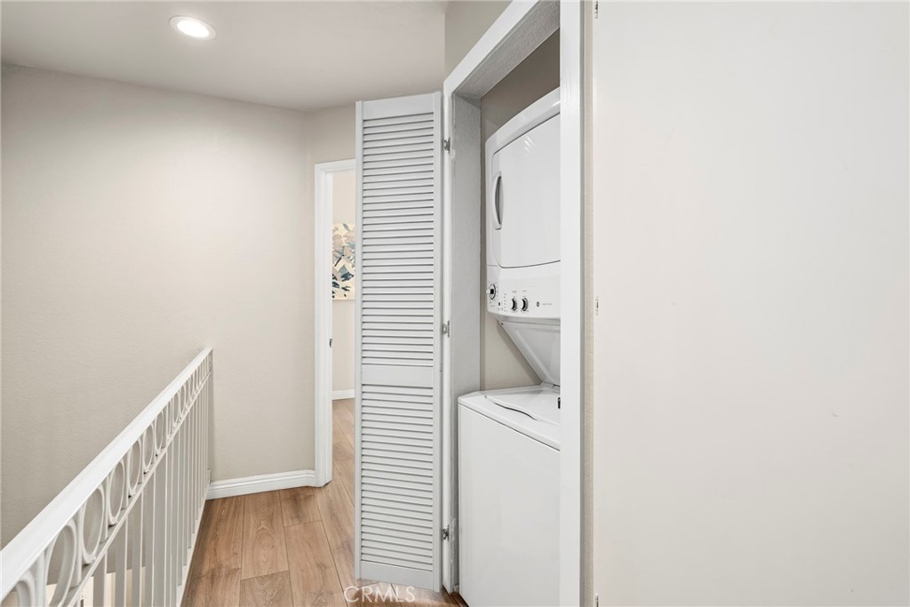 2000 Pacific Coast Highway, Unit 102 Huntington Beach, CA 92648 - Photo 24 of 35 a view of a hallway with wooden floor