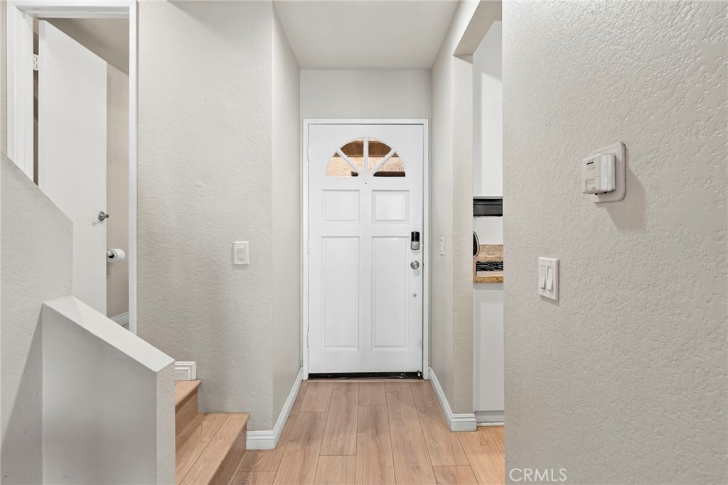 2000 Pacific Coast Highway, Unit 102 Huntington Beach, CA 92648 - Photo 4 of 35 a view of entryway with wooden floor