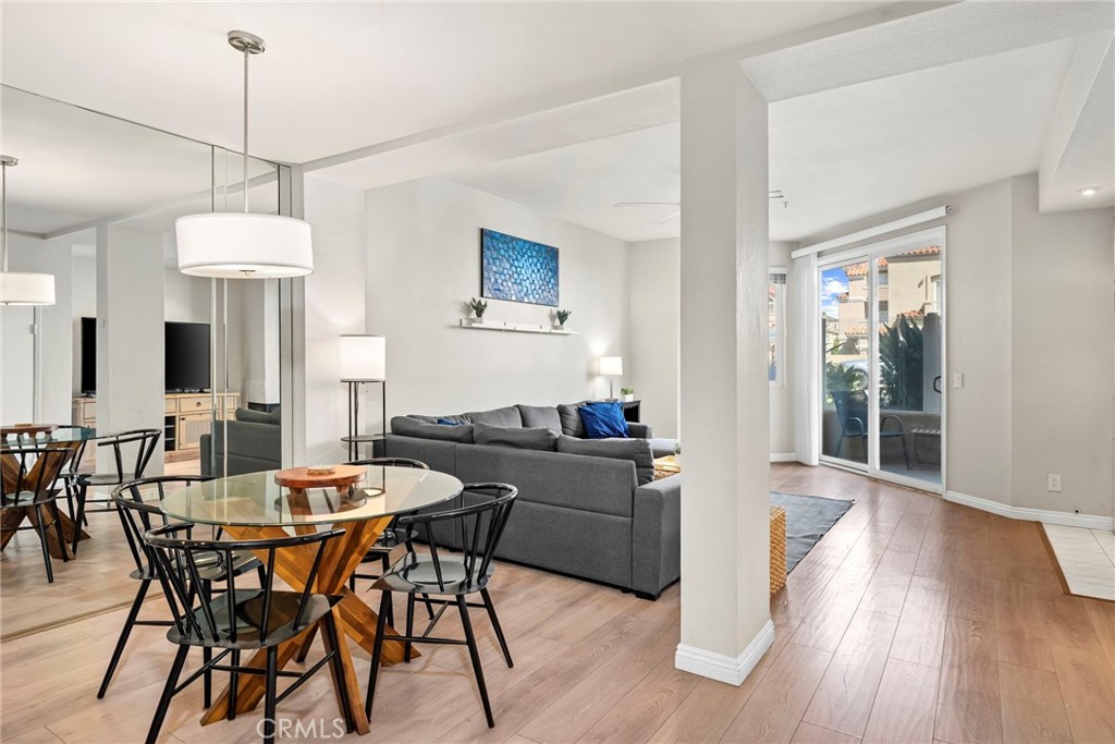 2000 Pacific Coast Highway, Unit 102 Huntington Beach, CA 92648 - Photo 5 of 35 a view of a dining room with furniture window and wooden floor
