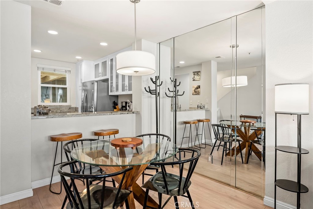 2000 Pacific Coast Highway, Unit 102 Huntington Beach, CA 92648 - Photo 6 of 35 a dining table chairs and a chandelier