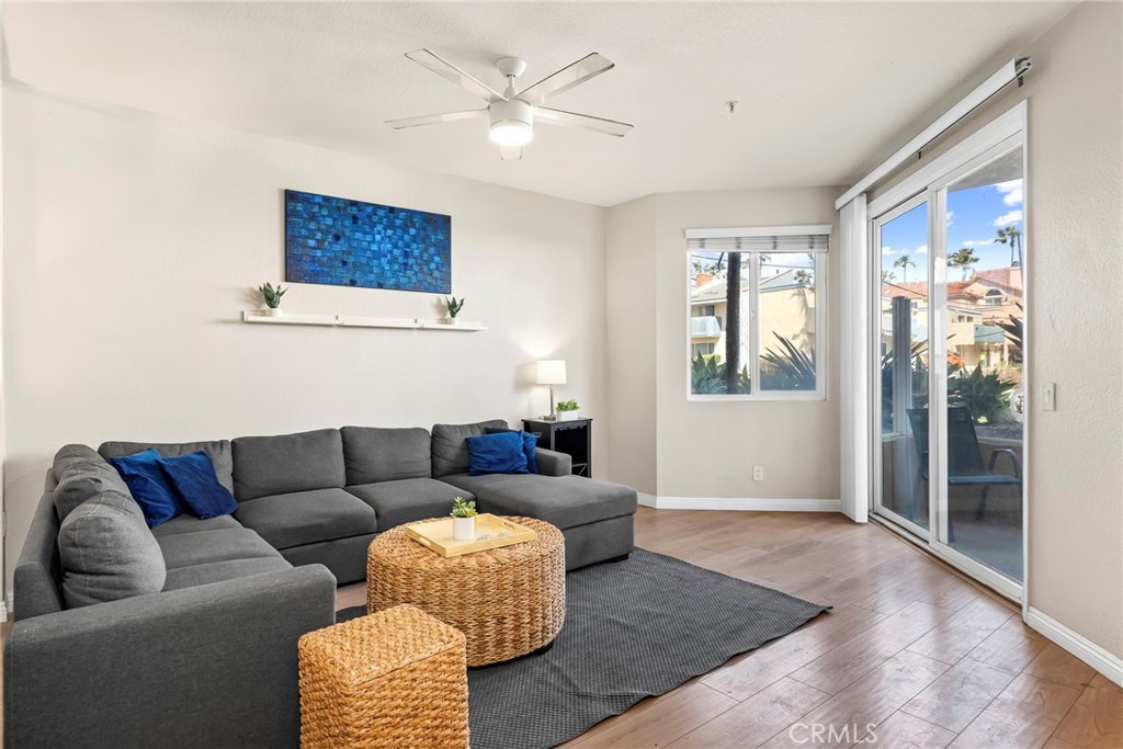 2000 Pacific Coast Highway, Unit 102 Huntington Beach, CA 92648 - Photo 7 of 35 a living room with furniture and a window