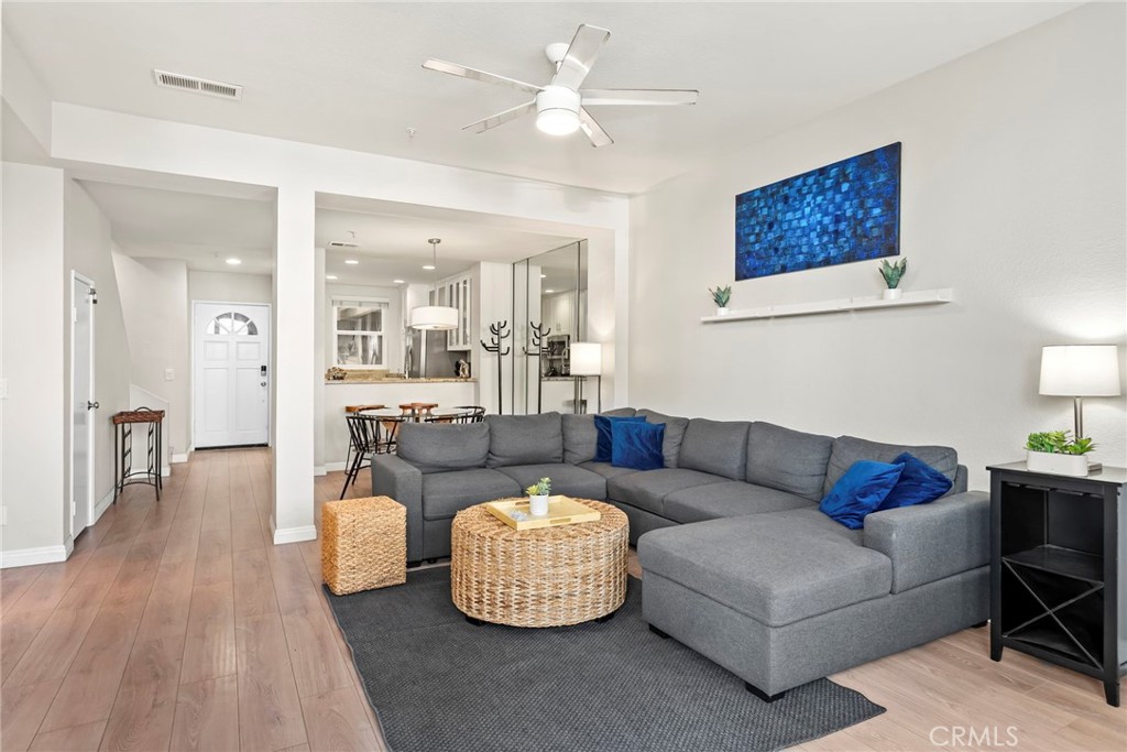 2000 Pacific Coast Highway, Unit 102 Huntington Beach, CA 92648 - Photo 9 of 35 a living room with furniture and a wooden floor