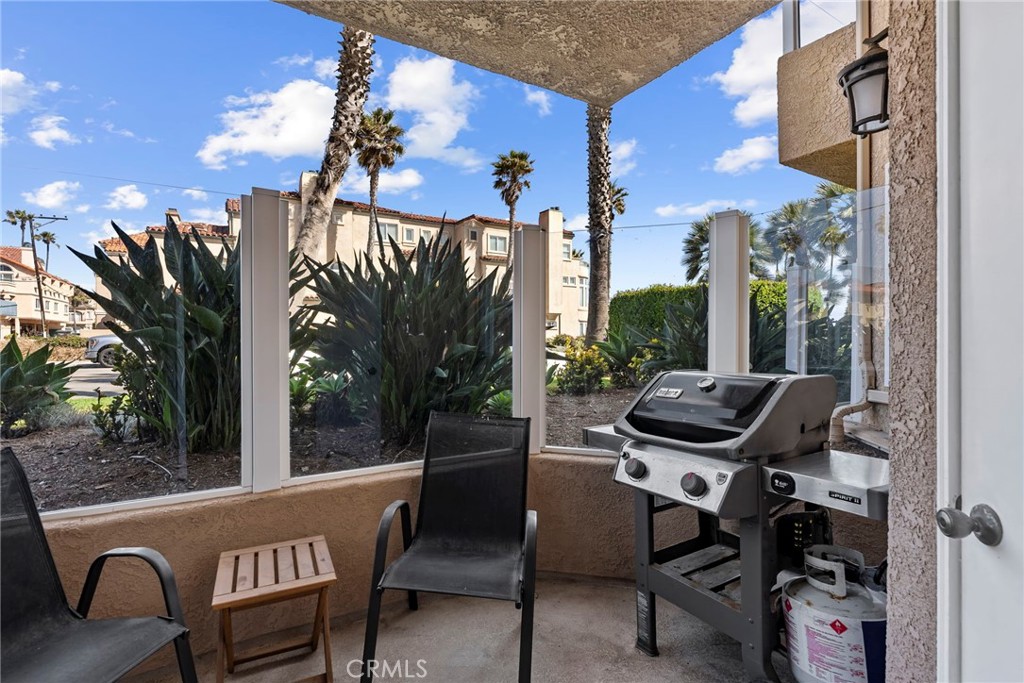 2000 Pacific Coast Highway, Unit 102 Huntington Beach, CA 92648 - Photo 10 of 35 a view of a chairs and table in the patio