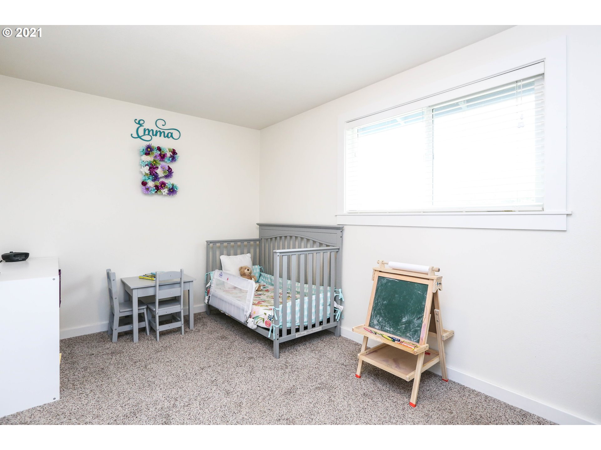 710 53rd Street Springfield, OR 97478 - Photo 13 of 16 a living room with a baby crib furniture and a window