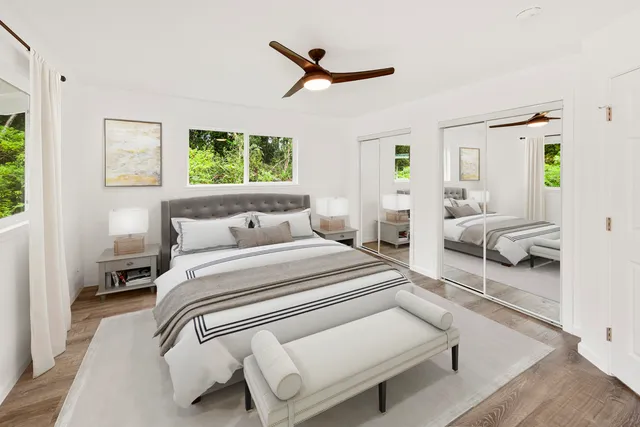 a bedroom with a bed couch and a window