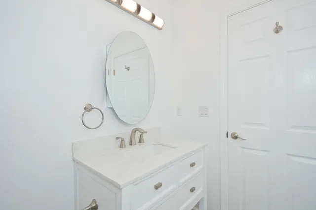 a bathroom with a sink and mirror