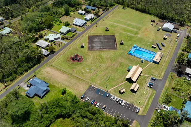 an aerial view of a house with a yard