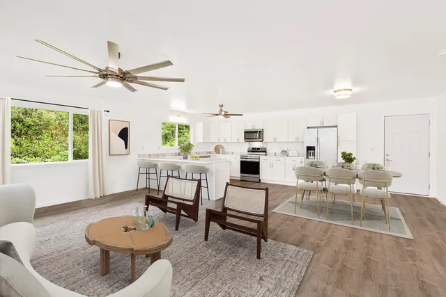 a living room with furniture a rug and a window