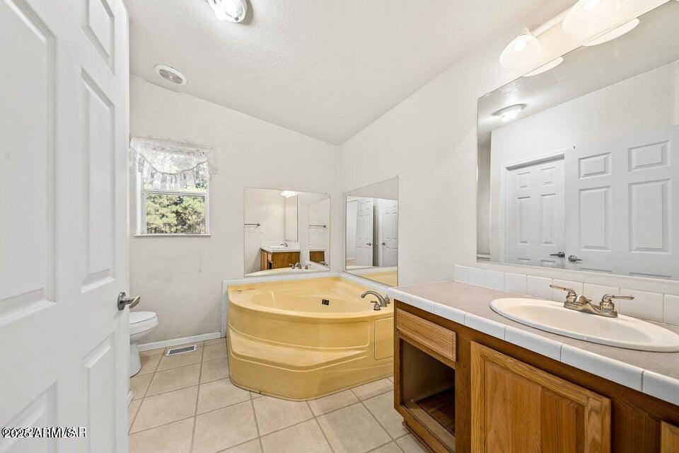 2421 West Thornton Road Show Low, AZ 85901 - Photo 22 of 48 a room with a sink a washer and dryer
