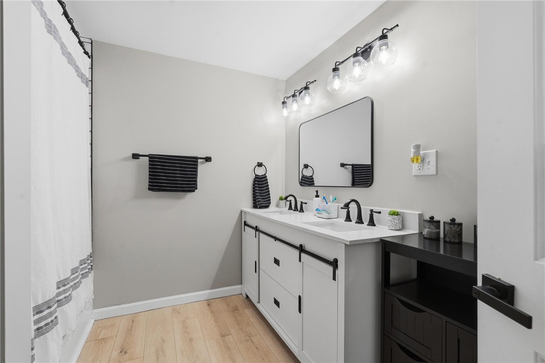 2950 Fairfield Pike Springfield, OH 45502 - Photo 24 of 48 This bright bathroom features dual sinks and ample vanity space, offering both style and functionality.