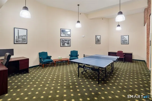 a living room with furniture a table and a chandelier