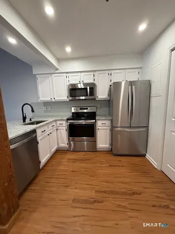 a kitchen with wooden cabinets and stainless steel appliances