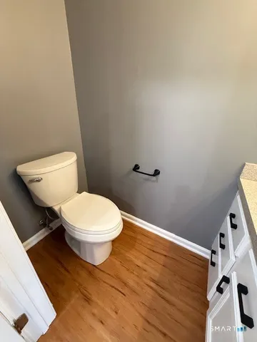 a white toilet sitting next to a white sink