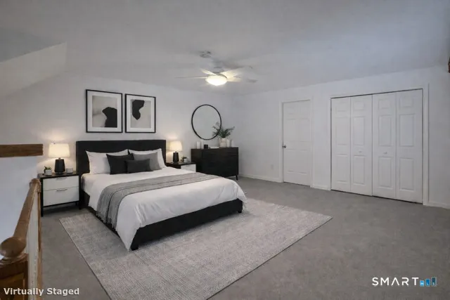 a bedroom with a bed and painting on the wall