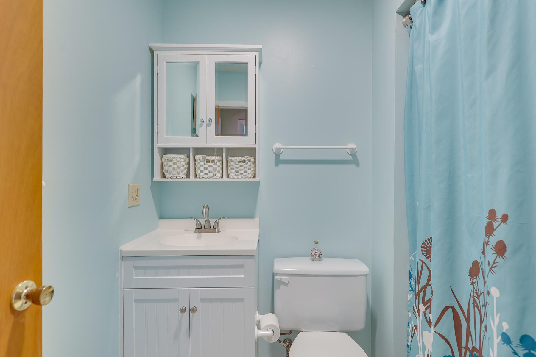 18 Round House Road Monument Beach, MA 02532 - Photo 11 of 16 a bathroom with a sink a toilet and shower curtain