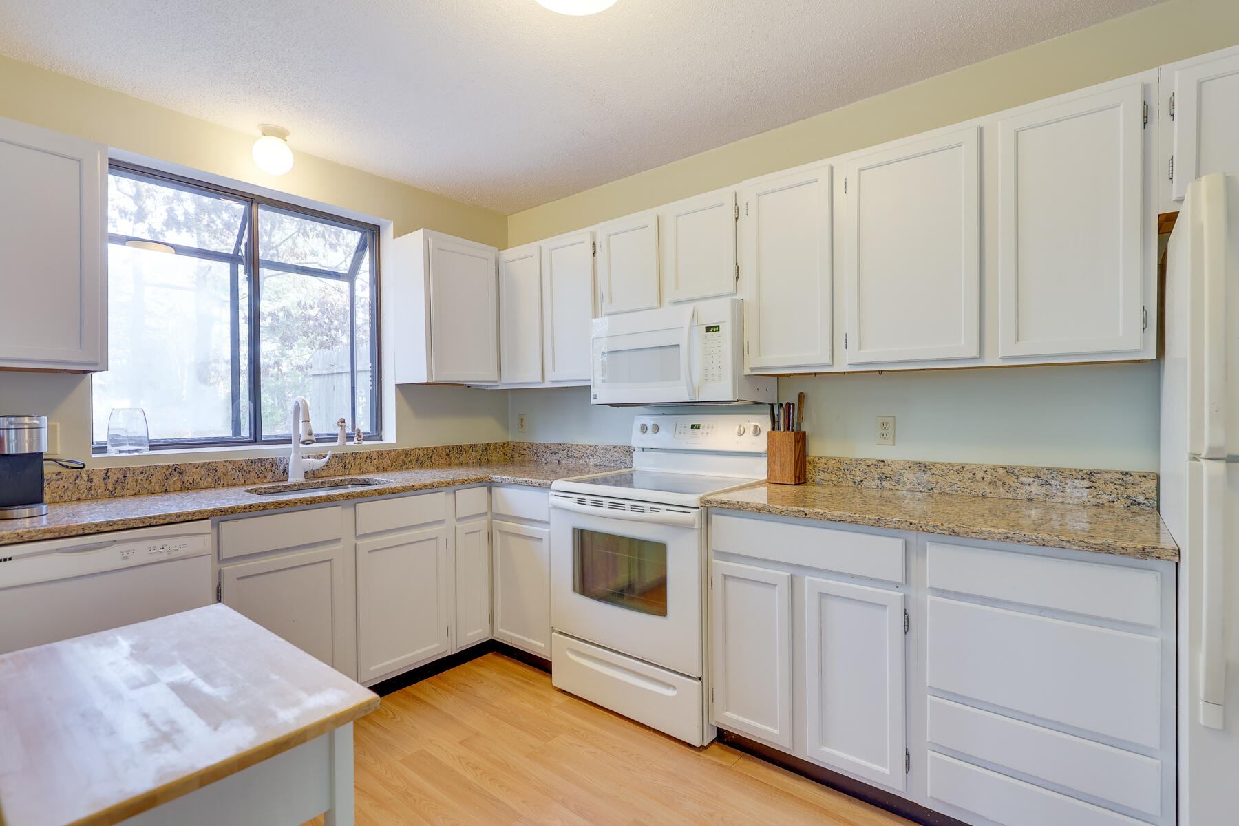 18 Round House Road Monument Beach, MA 02532 - Photo 8 of 16 a kitchen with granite countertop white cabinets and white appliances