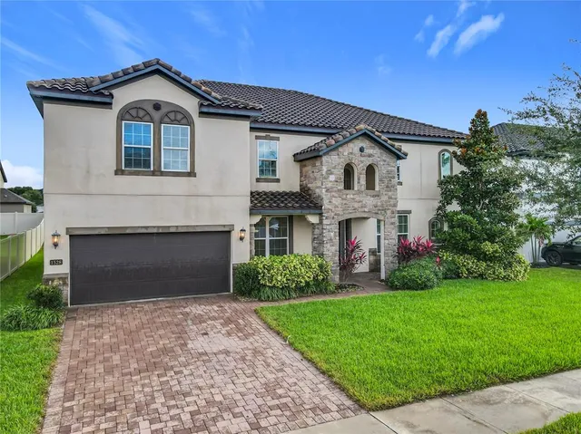 a front view of a house with a garden and plants