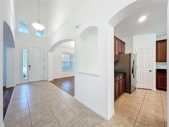 a view of a kitchen with a sink and refrigerator