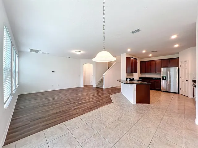 a view of kitchen with kitchen island microwave and stove