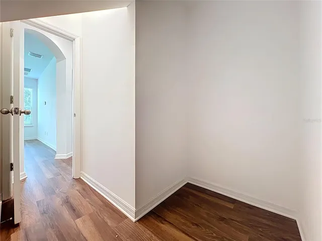 a view of a hallway with wooden floor