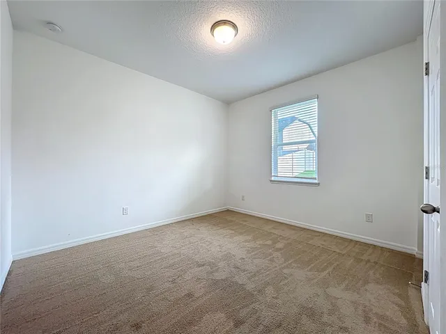 an empty room with a empty space and windows