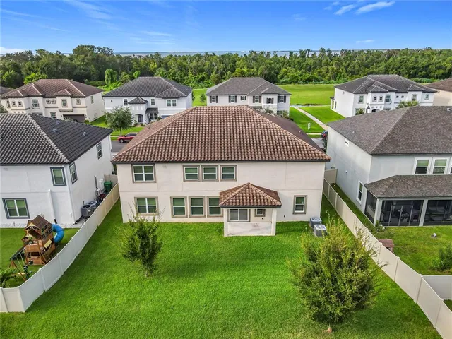 an aerial view of a house with swimming pool garden and mountain view