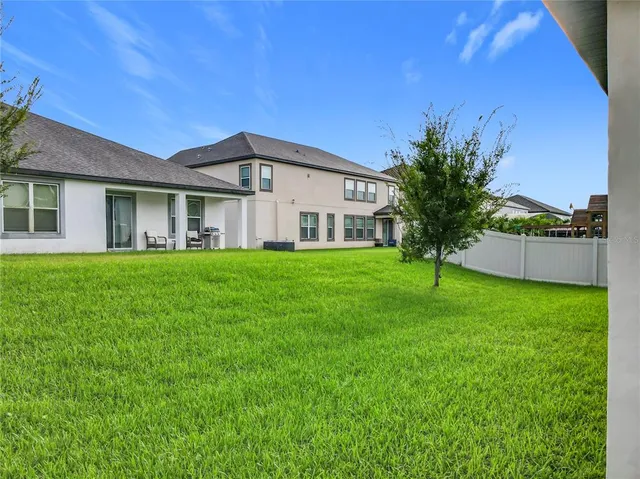 a front view of a house with a garden and yard