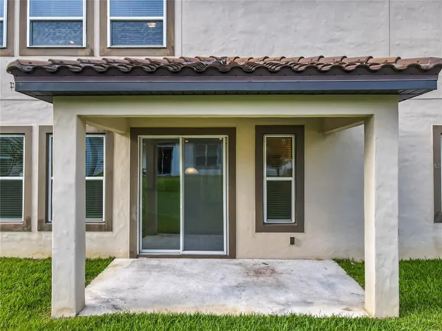a front view of a house with a garden and plants