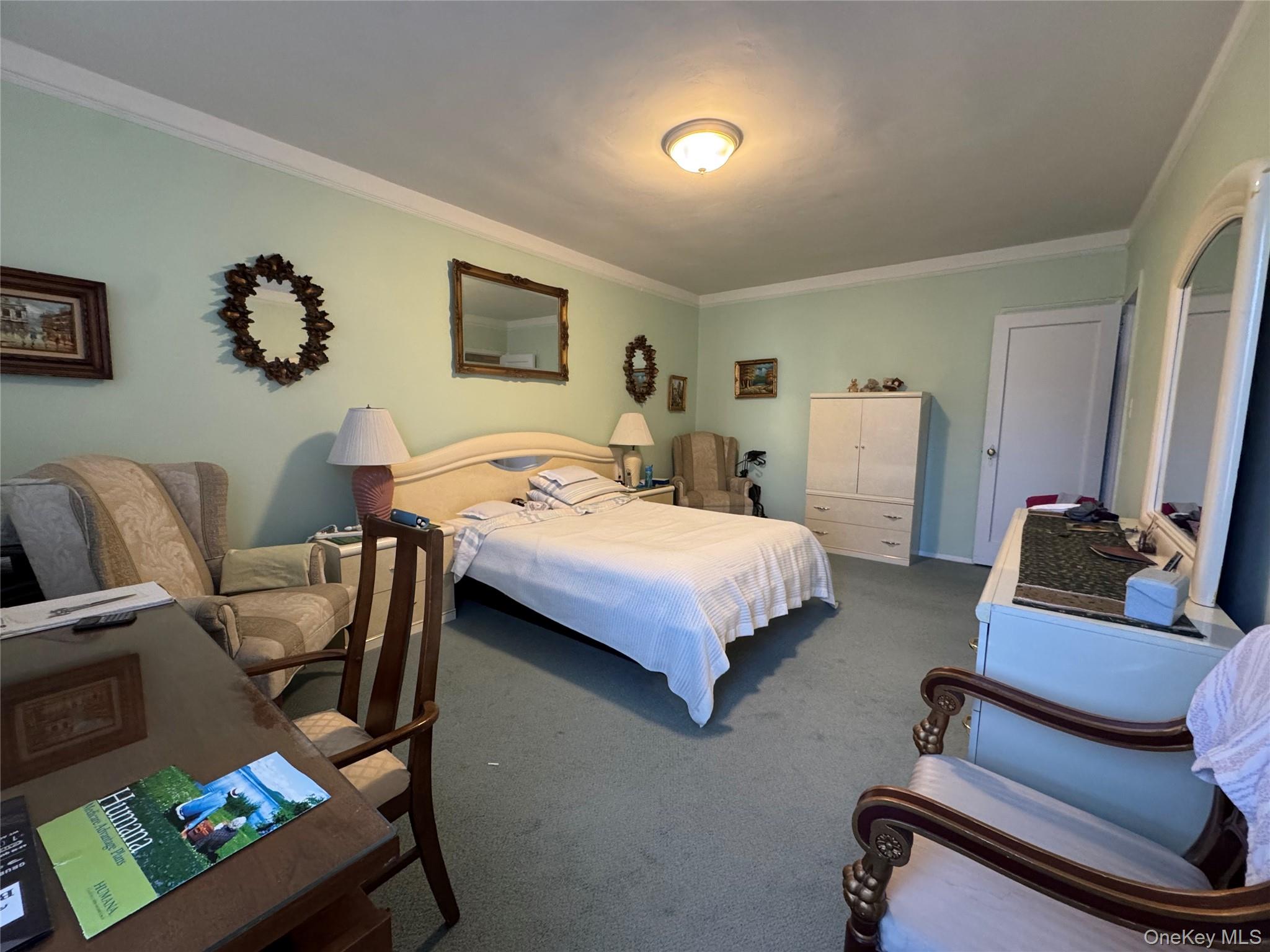 43-30 44th Street, Unit 3F Queens, NY 11104 - Photo 5 of 11 a bedroom with bed and a couch