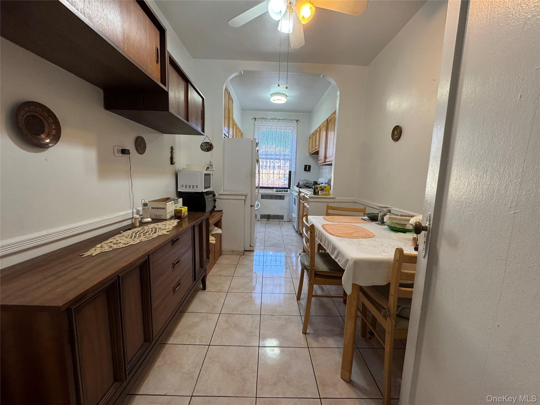 43-30 44th Street, Unit 3F Queens, NY 11104 - Photo 6 of 11 a kitchen with stainless steel appliances granite countertop a sink and a refrigerator
