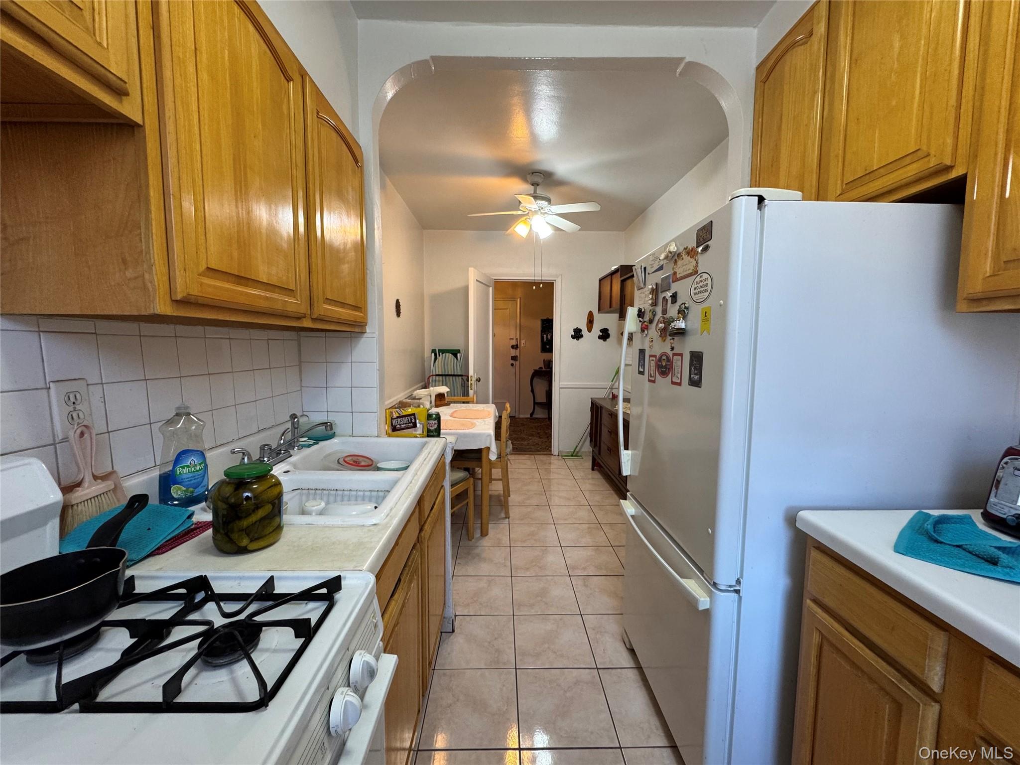 43-30 44th Street, Unit 3F Queens, NY 11104 - Photo 7 of 11 a kitchen with refrigerator and cabinets