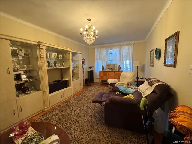 a living room with furniture chandelier and a window