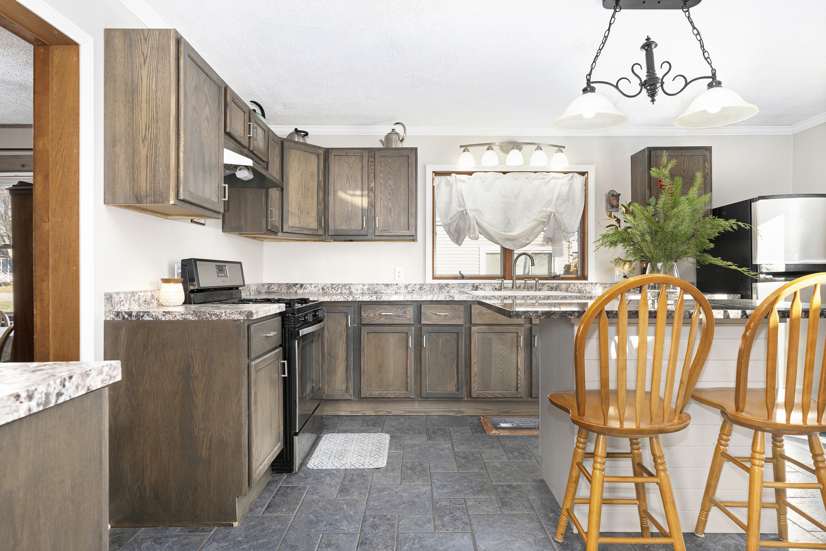 402 Center Street Mazon, IL 60444 - Photo 3 of 15 a kitchen with stainless steel appliances granite countertop a sink a stove and a wooden cabinets